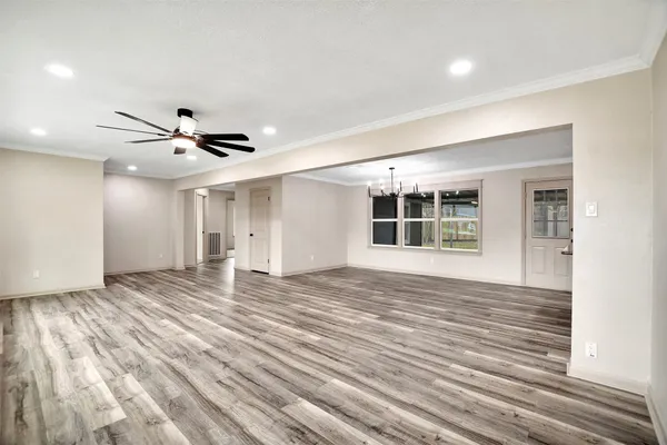 a view of kitchen and hall with wooden floor