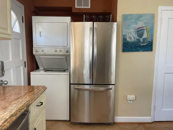 a view of a refrigerator in kitchen and wooden floor
