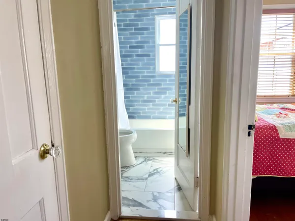 a view of a bathroom from a hallway