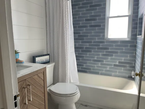 a bathroom with a sink a toilet and bathtub