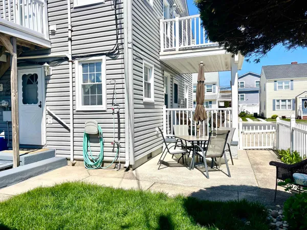 a view of a patio with table and chairs and potted plants