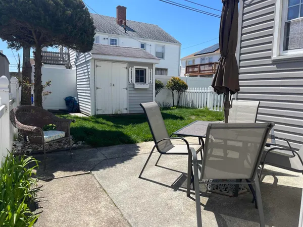a view of backyard of house with seating space