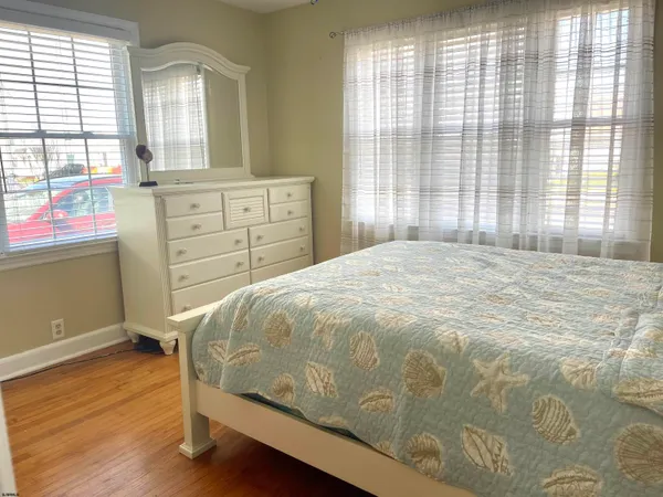 a bedroom with a bed and a closet with mirror
