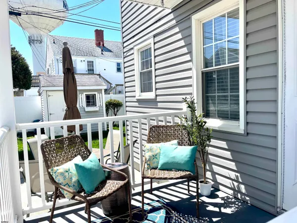 a balcony with table and chairs
