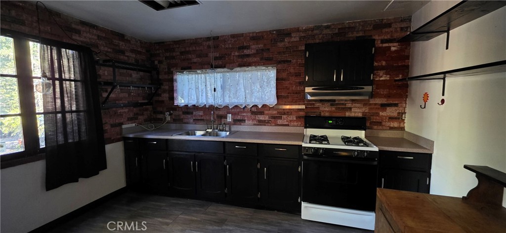 16455 French Town Road Brownsville, CA 95919 - Photo 10 of 26 a kitchen with stainless steel appliances granite countertop a refrigerator and a sink