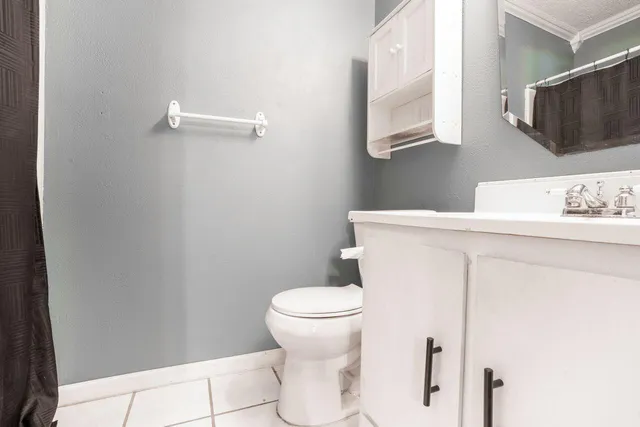 a white toilet sitting next to a bathroom sink