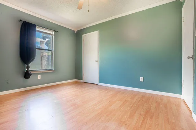 an empty room with windows and mirror