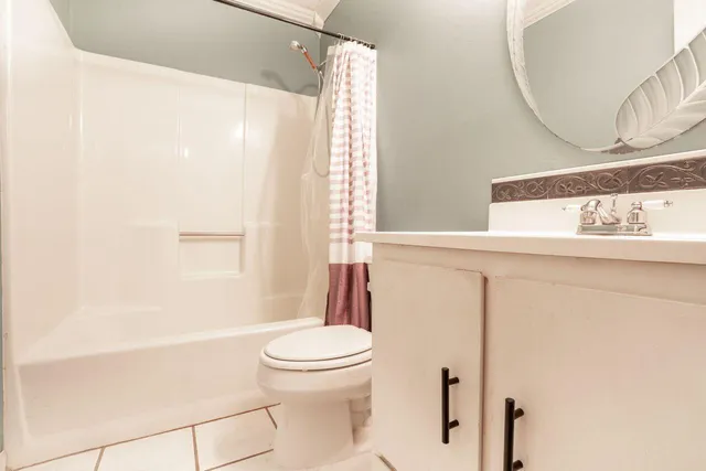 a white toilet sitting next to a bathroom sink