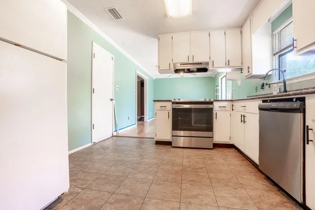 a kitchen with stainless steel appliances a stove and a refrigerator