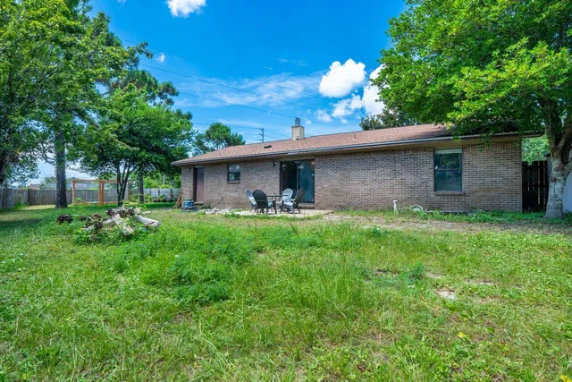 a front view of house with a garden