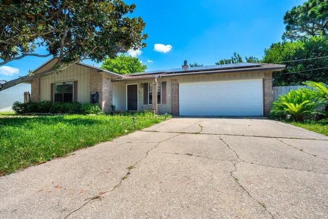 a front view of house with yard and trees