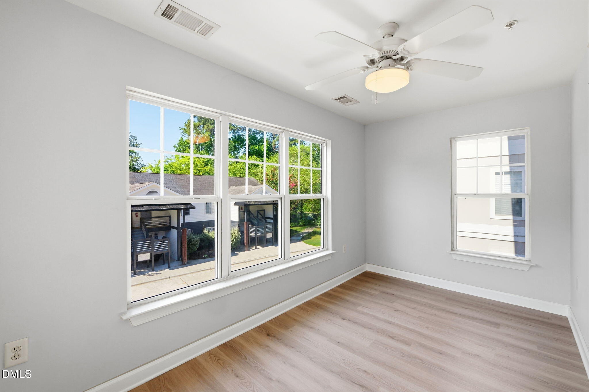 929 Morreene Road, Unit A23 Durham, NC 27705 - Photo 13 of 41 an empty room with wooden floor and windows