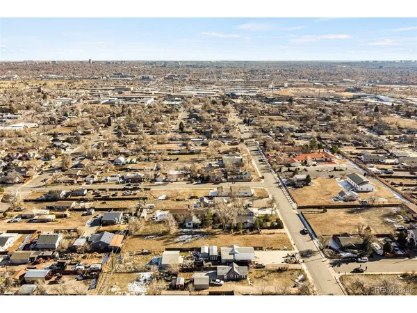 an aerial view of residential houses with city view