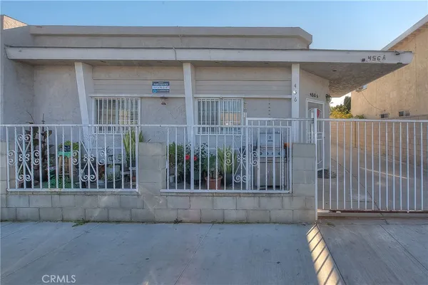 a view of a house with a wooden fence