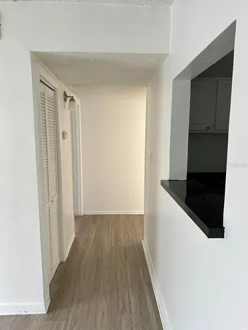 a view of a hallway with wooden floor