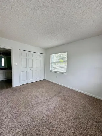 an empty room with a empty space and windows