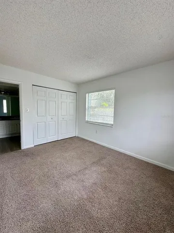 an empty room with a empty space and windows