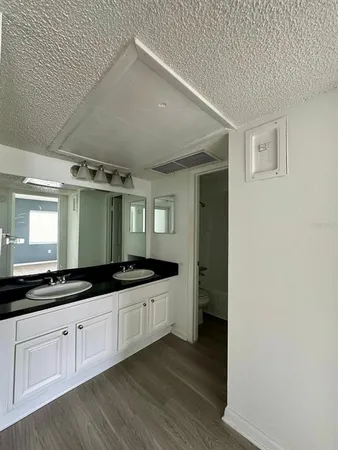 a kitchen with granite countertop a sink and cabinets