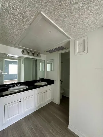 a kitchen with granite countertop a sink and cabinets