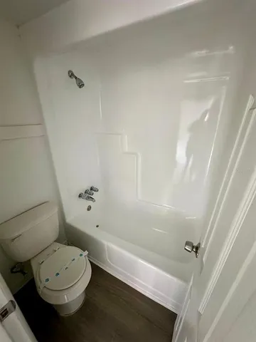 a bathroom with a toilet a sink and a bathtub