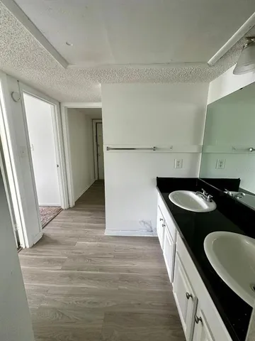 a kitchen with granite countertop a sink stove and cabinets