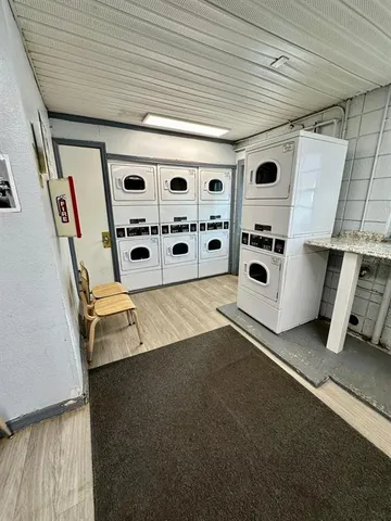 a view of kitchen with refrigerator and white wall