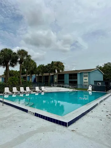 a view of a house with a yard patio and swimming pool