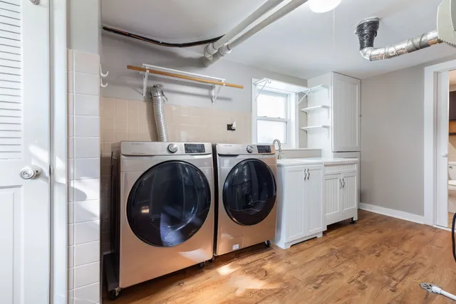 a utility room with sink dryer and washer