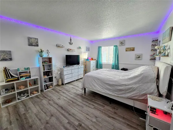 a bed room with a bed and a television