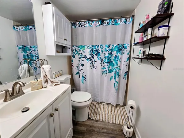 a bathroom with a sink toilet and a mirror