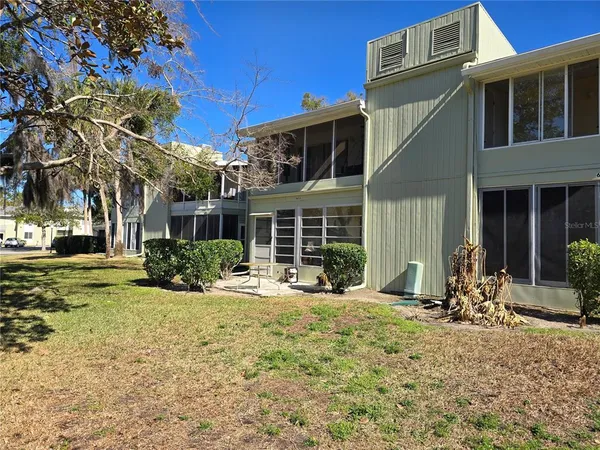 a front view of a house with a yard and seating space