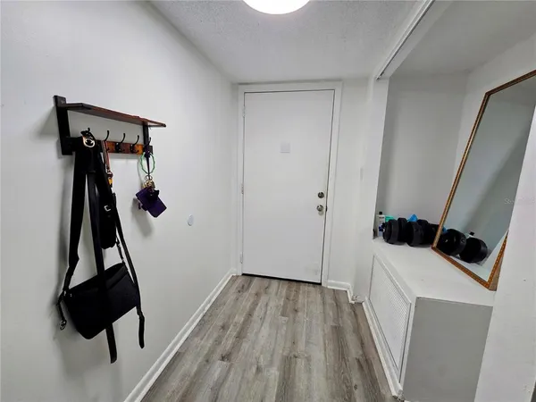 a view of a room with wooden floor and bathroom
