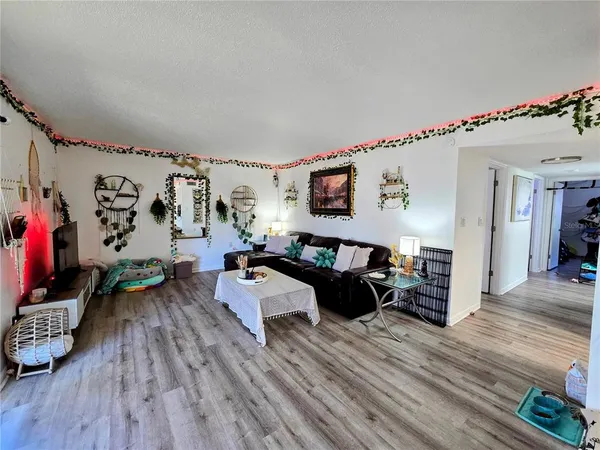 a living room with furniture and a wooden floor