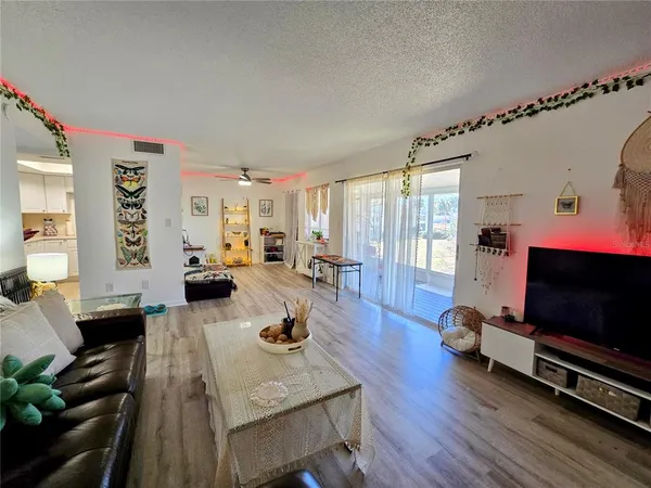 a living room with furniture flat screen tv and wooden floor