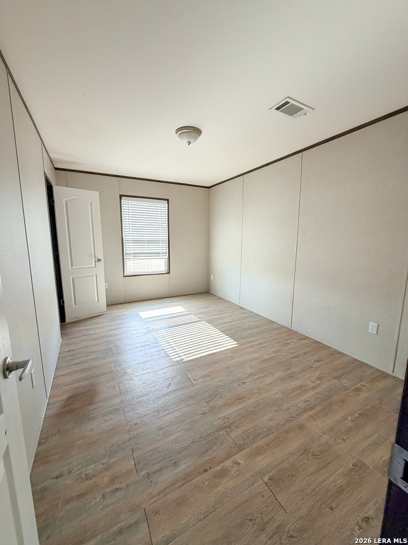 309 Jackson Refugio, TX 78377 - Photo 11 of 14 a view of empty room with wooden floor and fan