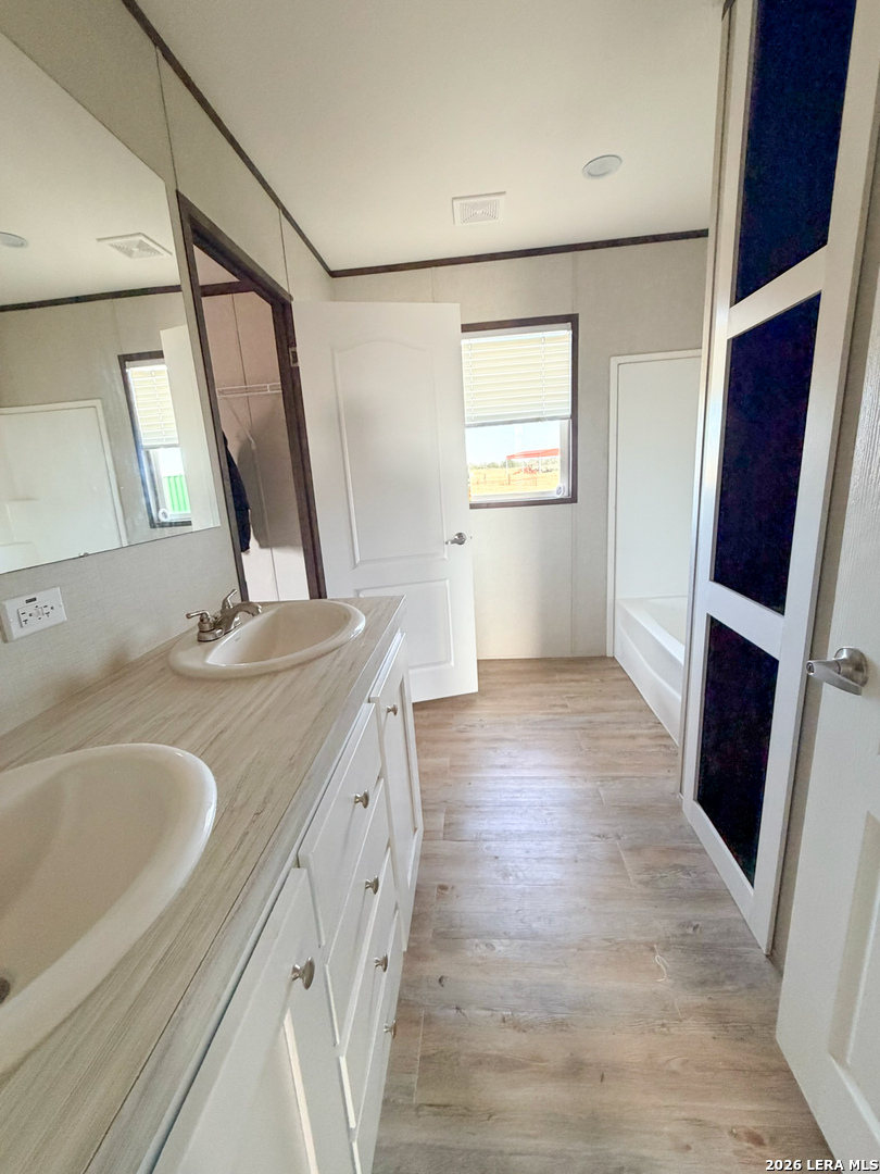 309 Jackson Refugio, TX 78377 - Photo 14 of 14 a bathroom with a sink and a large mirror