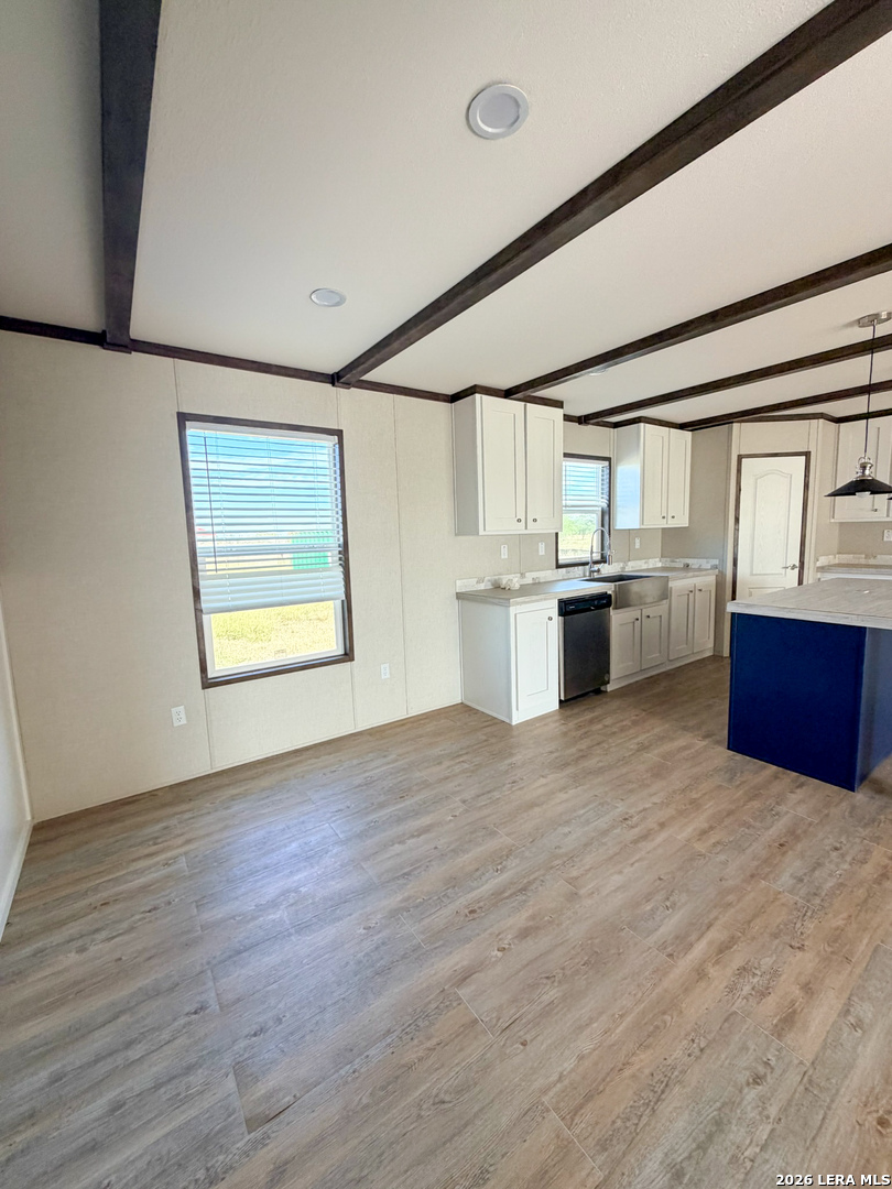309 Jackson Refugio, TX 78377 - Photo 4 of 14 a kitchen with stainless steel appliances granite countertop a stove and a refrigerator