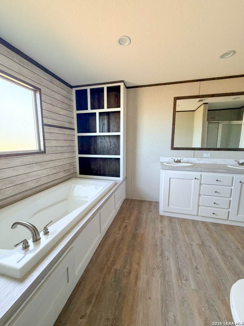 309 Jackson Refugio, TX 78377 - Photo 9 of 14 a bathroom with a bathtub and a sink