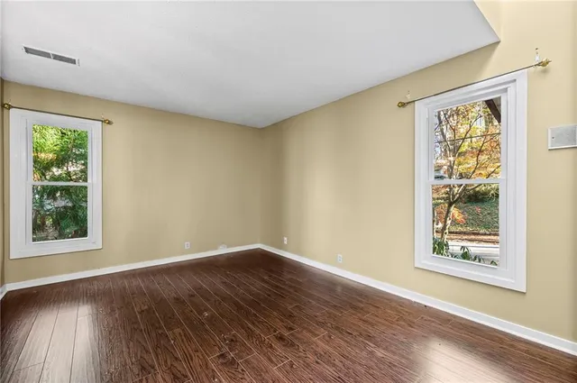 a view of an empty room with wooden floor