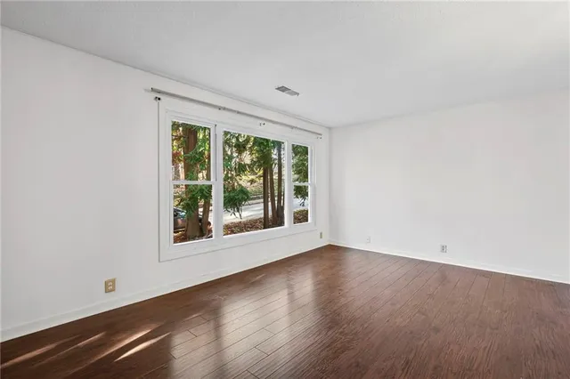 an empty room with wooden floor
