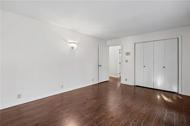 a view of a room with wooden floor and fan