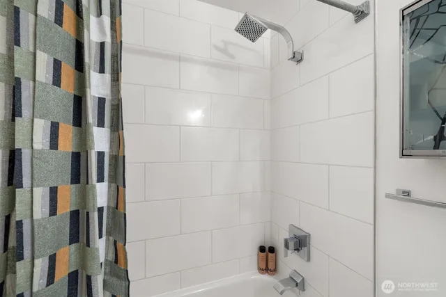 a bathroom with a bathtub and shower