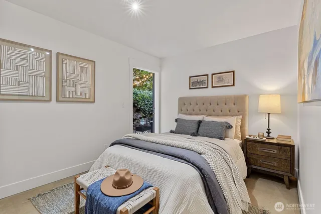 a bedroom with a bed and a window