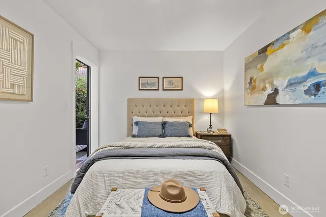 a bedroom with a bed and a painting on the wall