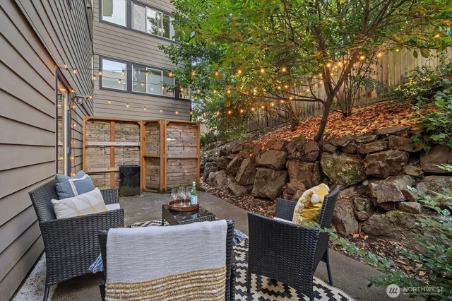 a view of a patio with couches table and chairs and potted plants
