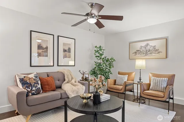a living room with furniture a chandelier and a potted plant