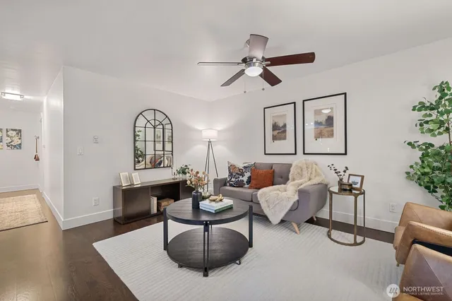 a living room with furniture and wooden floor