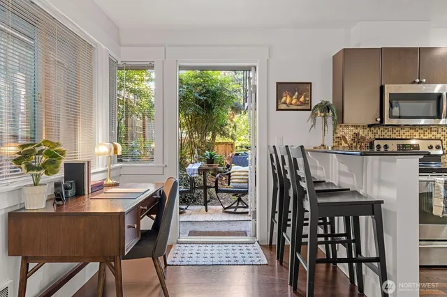 a view of a dining room with furniture and a window