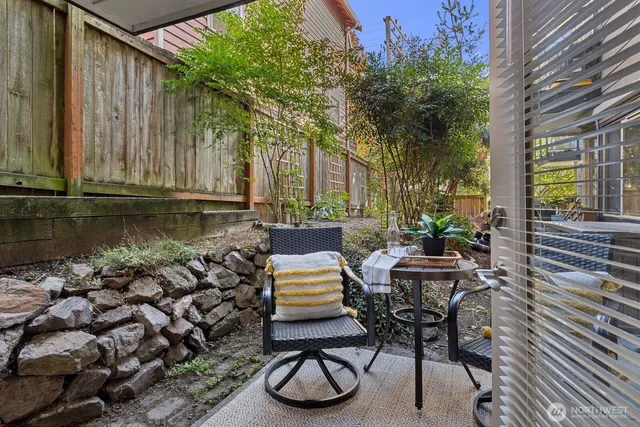a view of a chairs and tables in the back yard of the house