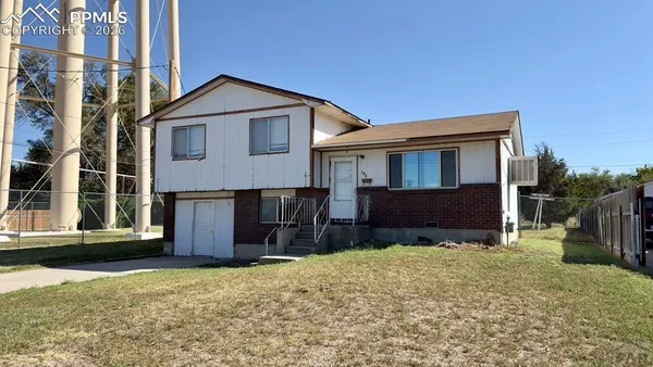 a front view of house with yard outdoor seating and barbeque oven